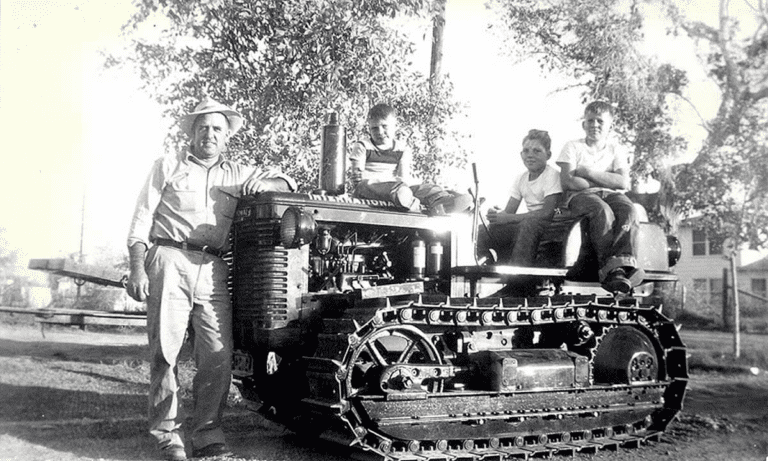great dpression era family with dad and boys on tractor