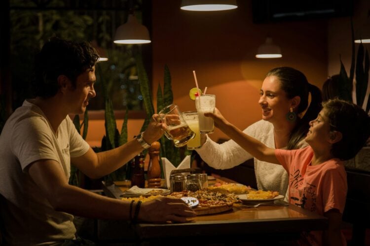 family at table with milkshakes